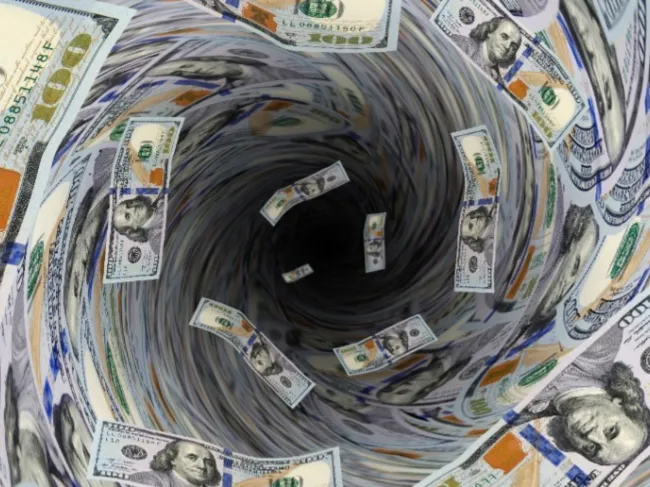 money falling in hole